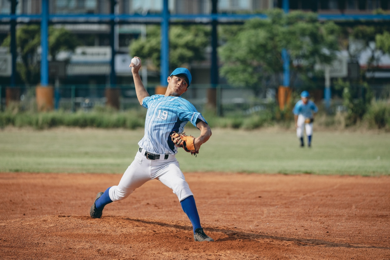The pitcher throws the ball towards the catcher